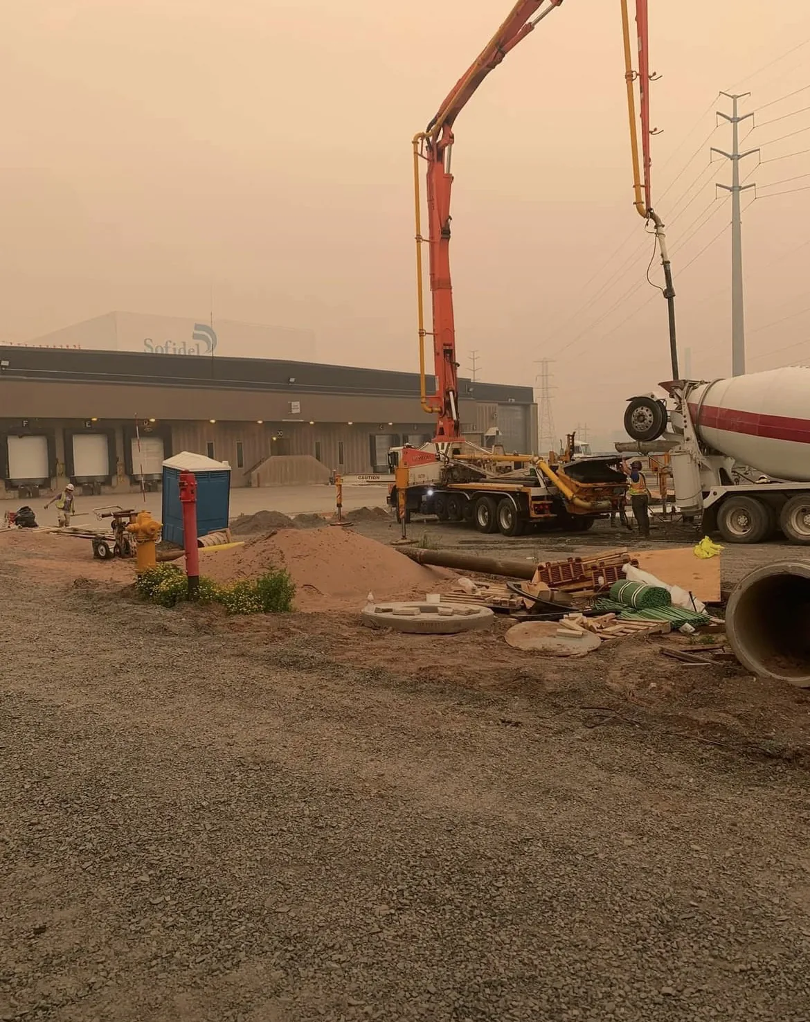 Concrete pump and crew working on a construction site