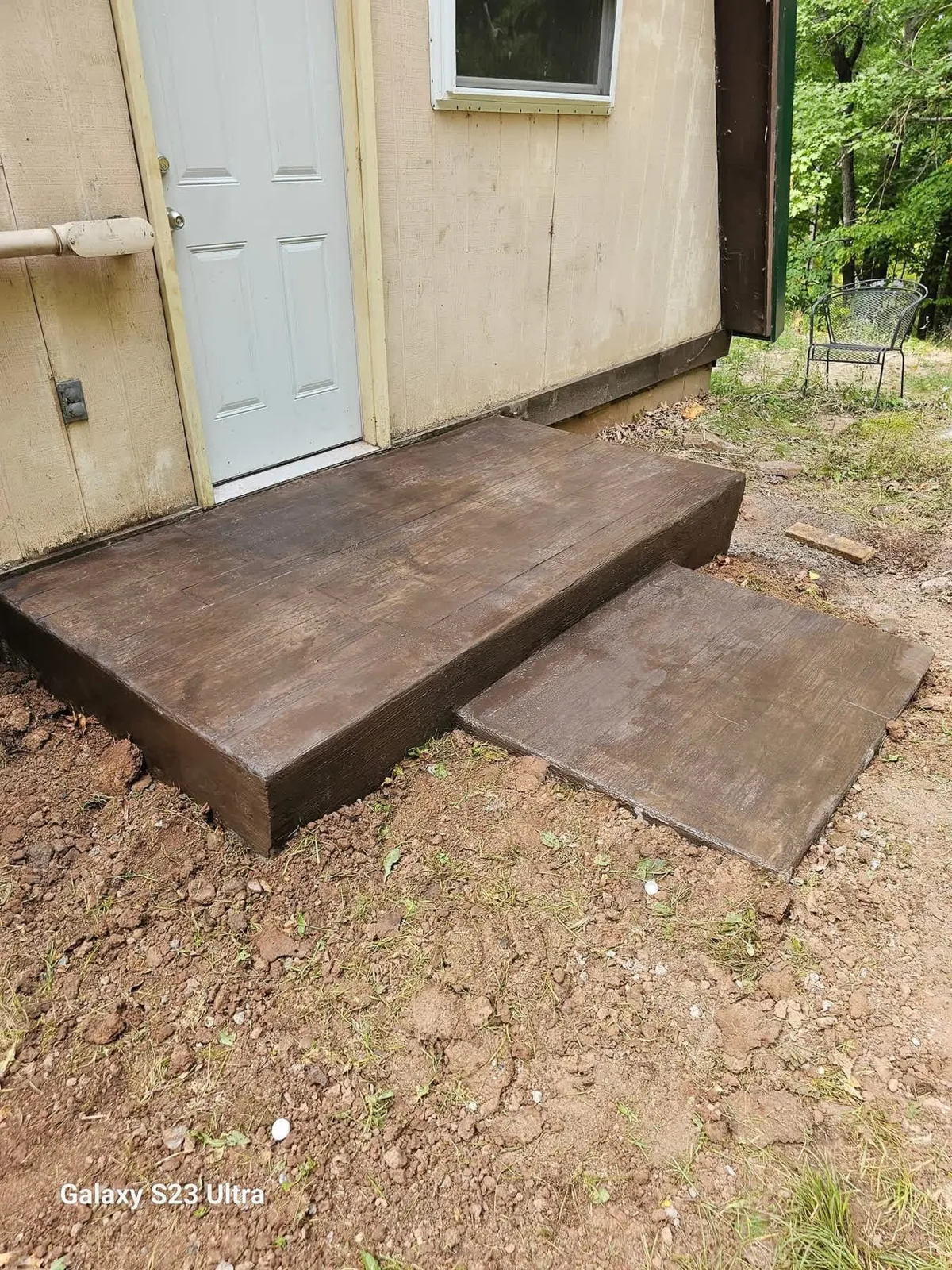Finished concrete stoop at an exterior door
